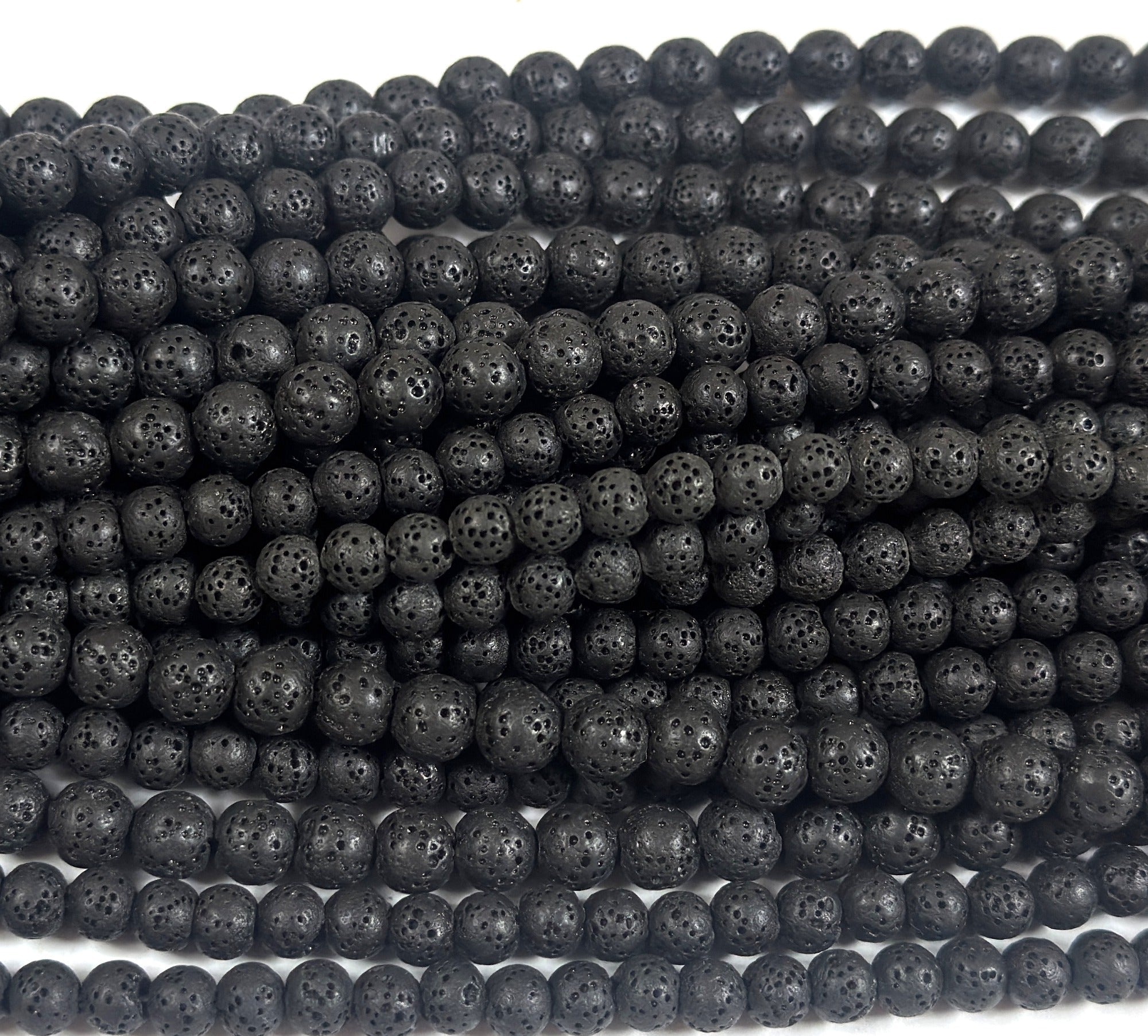 Natural black lava diffuser beads on 15.5-inch strand; 6/8/10mm round, porous with 2mm holes.