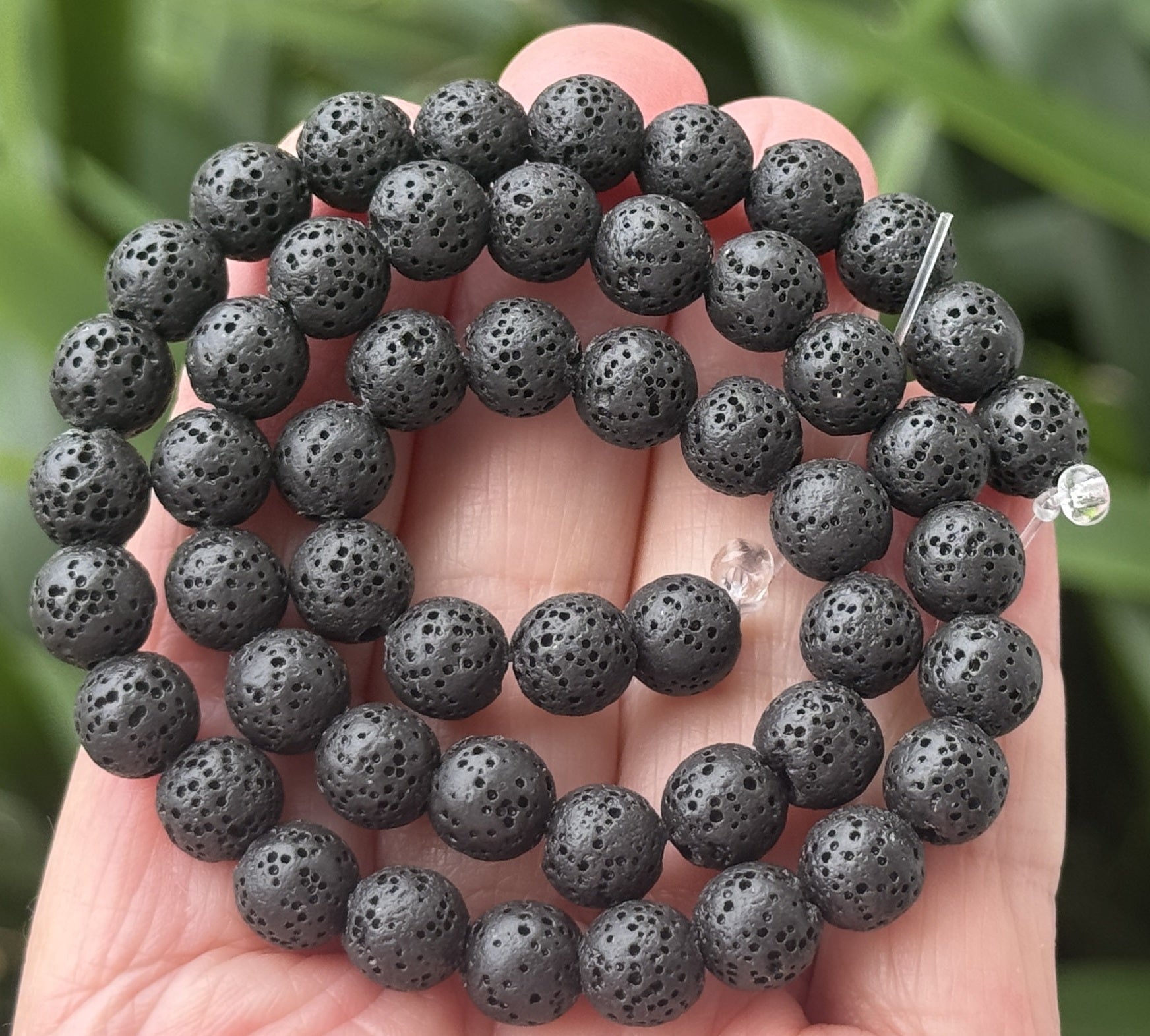 Black lava diffuser beads on a 15.5 inch strand; natural volcanic lava, dyed black and waxed, 6.5–10.5 mm, 2 mm hole.
